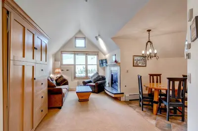 a living room with a table and a dining room at River Run Village by Vail Resorts in Keystone