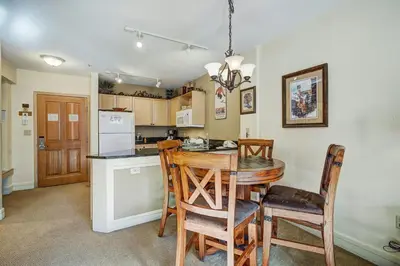 a kitchen with a dining room table and chairs at River Run Village by Vail Resorts in Keystone