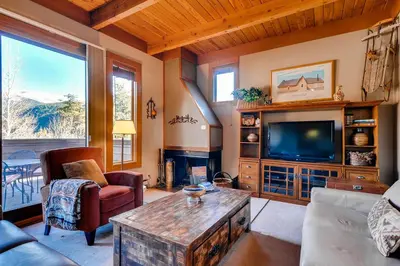 a living room with a couch and a tv at Aspen Ridge Condominiums by Vail Resorts in Keystone