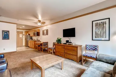 a living room with a couch and a table at Mountain House, A Vail Resorts Property in Keystone