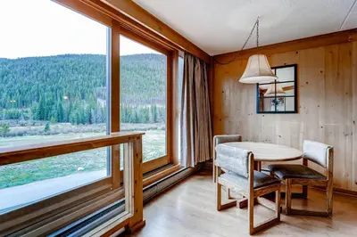 a dining room with a table and a large window at Lakeside Village by Vail Resorts in Keystone