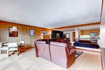 a living room with a couch and a dining room at Lakeside Village by Vail Resorts in Keystone