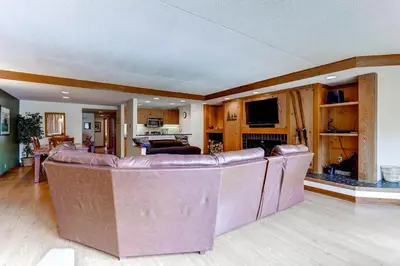 a living room with a bunch of leather chairs at Lakeside Village by Vail Resorts in Keystone