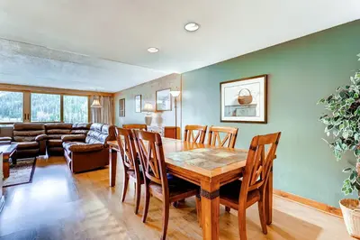 a dining room and living room with a table and chairs at Lakeside Village by Vail Resorts in Keystone