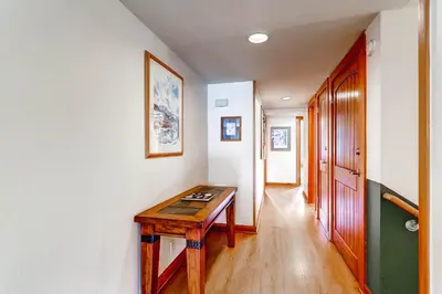 a hallway with a wooden table in a room at Lakeside Village by Vail Resorts in Keystone