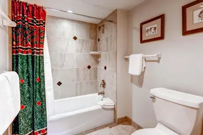 a bathroom with a tub and a toilet and a shower at Lakeside Village by Vail Resorts in Keystone