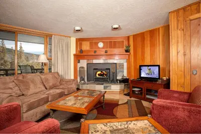 a living room with a couch and a fireplace at Evergreen Condominiums by Vail Resorts in Keystone