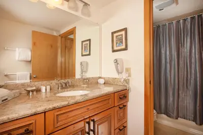 a bathroom with a sink and a mirror at Evergreen Condominiums by Vail Resorts in Keystone