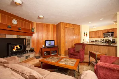 a living room with a couch and a fireplace at Evergreen Condominiums by Vail Resorts in Keystone