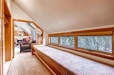 a room with a large window in a house at Evergreen Condominiums by Vail Resorts in Keystone