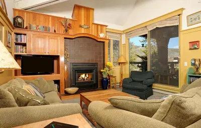 a living room with two couches and a fireplace at Forest Condominiums by Vail Resorts in Keystone