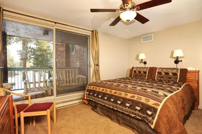 a bedroom with a bed and a large window at Forest Condominiums by Vail Resorts in Keystone