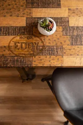 a wooden table with a bowl of plants on it at The Eddy Taproom & Hotel in Golden