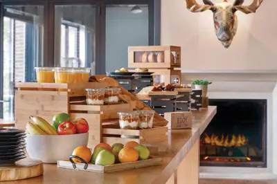 a kitchen with crates of fruit on a counter with a fireplace at The Eddy Taproom & Hotel in Golden
