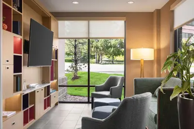 a waiting room with chairs and a large window at Home2 Suites by Hilton Denver West / Federal Center in Lakewood