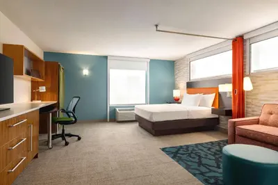 a bedroom with a bed and a desk and a chair at Home2 Suites by Hilton Denver West / Federal Center in Lakewood