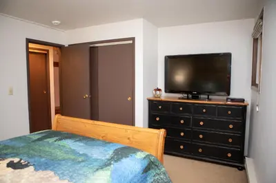 a bedroom with a television on top of a dresser at 1168 Flying Dutchman condo in Keystone