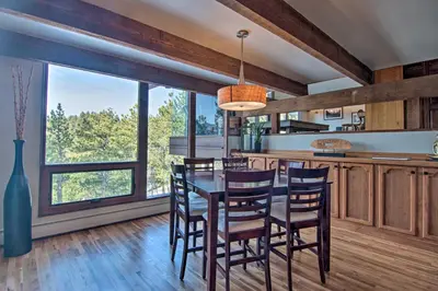 a kitchen with a table and chairs and a large window at Chic Boulder Mountain Home with Hot Tub and Views in Boulder