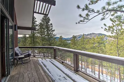 a balcony with a chair and a view of the mountains at Chic Boulder Mountain Home with Hot Tub and Views in Boulder
