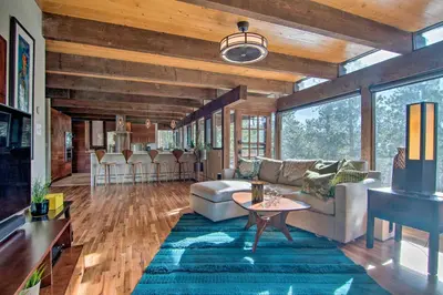 a living room with a couch and a table at Chic Boulder Mountain Home with Hot Tub and Views in Boulder