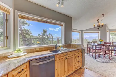 a kitchen with a sink and a large window at Mountain Views and Hot Tub Airy Forest Escape! in Black Hawk