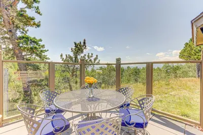 a table and chairs on a balcony with a view at Mountain Views and Hot Tub Airy Forest Escape! in Black Hawk