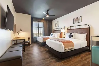 a hotel room with two beds and a television at Origin Westminster a Wyndham Hotel in Westminster