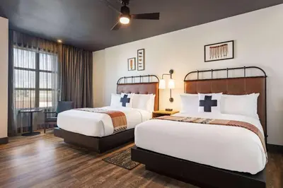 a hotel room with two beds and a desk at Origin Westminster a Wyndham Hotel in Westminster