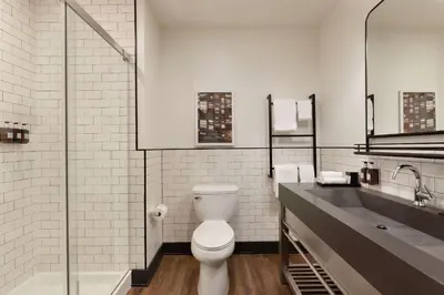 a bathroom with a toilet and a sink at Origin Westminster a Wyndham Hotel in Westminster