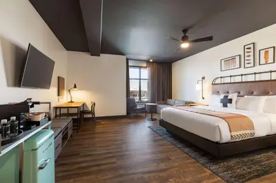 a hotel room with a large bed and a kitchen at Origin Westminster a Wyndham Hotel in Westminster