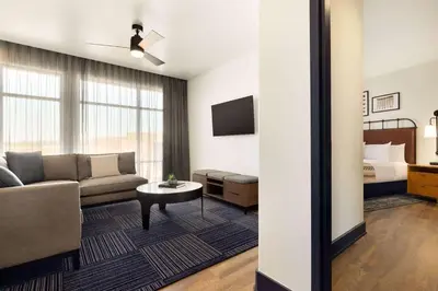a living room with a couch and a bed at Origin Westminster a Wyndham Hotel in Westminster