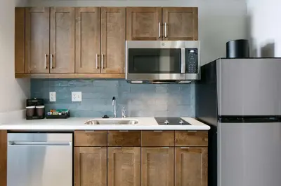 a kitchen with a sink and a microwave and a refrigerator at Homewood Suites By Hilton Dillon in Dillon