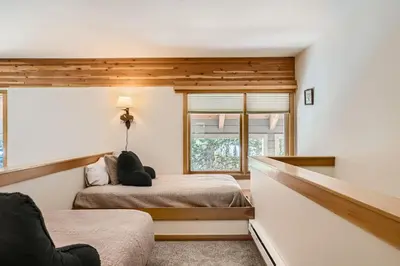 a bedroom with two beds and a window at 2084 The Pines condo in Keystone