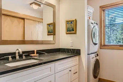 a kitchen with a sink and a refrigerator at 2084 The Pines condo in Keystone