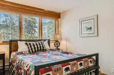 a bedroom with a bed and a window at 2084 The Pines condo in Keystone