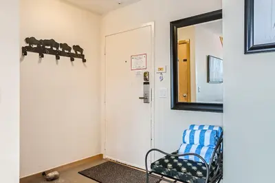 a hallway with a chair and a mirror at 2084 The Pines condo in Keystone