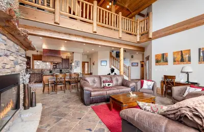 a living room with leather furniture and a fireplace at Elk Summit Vacation Home at Windcliff home in Estes Park