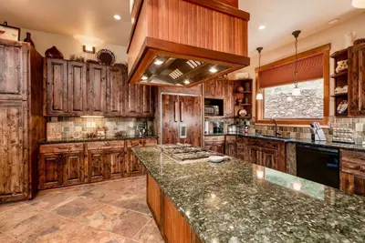 a large kitchen with wooden cabinets and a counter top at Elk Summit Vacation Home at Windcliff home in Estes Park