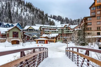 a town in the snow with a bridge at Ski-In Ski-Out Modern Mountain Condo in Winter Park