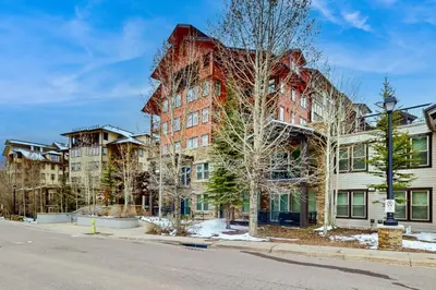 an apartment building on the corner of a street at Ski-In Ski-Out Modern Mountain Condo in Winter Park