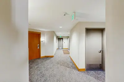 an empty hallway with two doors and a hallway at Ski-In Ski-Out Modern Mountain Condo in Winter Park