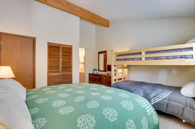 a bedroom with two beds and a bunk bed at Colorado Ski Condo in the Heart of Winter Park in Winter Park