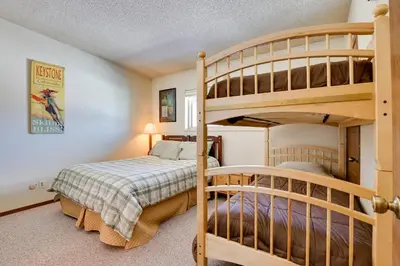 a bedroom with a bunk bed and two bunk beds at Colorado Ski Condo in the Heart of Winter Park in Winter Park