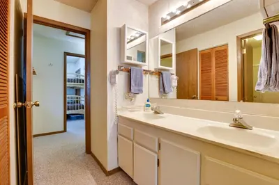 a bathroom with a sink and a mirror at Colorado Ski Condo in the Heart of Winter Park in Winter Park