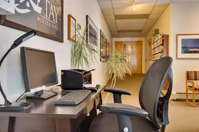 an office with a desk with a computer and two chairs at Colorado Ski Condo in the Heart of Winter Park in Winter Park