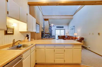 an open kitchen with a sink and a living room at Colorado Ski Condo in the Heart of Winter Park in Winter Park