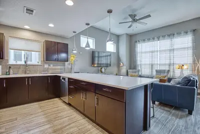 a kitchen with a large island in the middle at Modern Townhome near Old Town, Breweries, & River! in Fort Collins