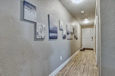 a hallway with many pictures on the wall at Modern Townhome near Old Town, Breweries, & River! in Fort Collins