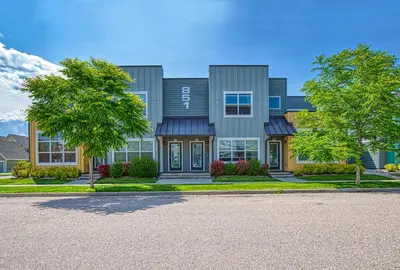 a large house with a driveway in front of it at Modern Townhome near Old Town, Breweries, & River! in Fort Collins