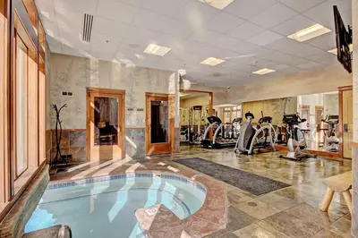 a gym with a swimming pool in the middle of a room at 3059 The Timbers condo in Keystone